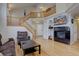 Spacious living area with fireplace, staircase, and an open layout at 19414 E Mann Creek Dr # C, Parker, CO 80134