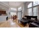 Bright living room with high ceilings, hardwood floors, and large windows at 19414 E Mann Creek Dr # C, Parker, CO 80134