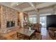 Lobby area with a stone fireplace, brown sofa, and a patterned rug and coffee table at 19414 E Mann Creek Dr # C, Parker, CO 80134