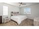 Bright bedroom with a fan, two windows, neutral tones, and cozy carpet flooring at 6317 Vista Cliff Loop, Castle Rock, CO 80104