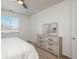 Bright bedroom featuring a dresser, a large window, and neutral decor at 6317 Vista Cliff Loop, Castle Rock, CO 80104