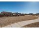 Serene community featuring a paved path meandering through picturesque homes on a sunny day with vibrant blue sky at 6317 Vista Cliff Loop, Castle Rock, CO 80104