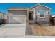 Charming single-Gathering home with a two-car garage, neutral paint, and stone accents at 6317 Vista Cliff Loop, Castle Rock, CO 80104