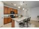 This kitchen features granite counters, wood cabinets, stainless appliances, and barstool seating at the island at 6317 Vista Cliff Loop, Castle Rock, CO 80104