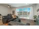 Living room with a view of the fenced-in backyard through the glass doors and modern gray furniture at 6317 Vista Cliff Loop, Castle Rock, CO 80104