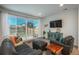 Living room with modern furniture, large sliding glass doors leading to the fenced-in backyard, and a mounted TV at 6317 Vista Cliff Loop, Castle Rock, CO 80104
