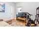 Bedroom with hardwood floors and a media center featuring a large television, and an exercise bike at 4054 Wyandot St, Denver, CO 80211