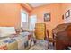 Charming bedroom with an antique wooden roll-top desk, a vibrant area rug, and a cozy patchwork quilt at 4054 Wyandot St, Denver, CO 80211