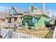 Charming green home with a peaked roof, complemented by a white picket fence at 4054 Wyandot St, Denver, CO 80211