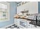 Charming kitchen featuring bright white cabinets, checkerboard flooring, stainless steel appliances, and ample natural light at 4054 Wyandot St, Denver, CO 80211