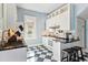 Bright kitchen with stainless steel appliances, white cabinets, a black countertop, and blue-and-white checkerboard flooring at 4054 Wyandot St, Denver, CO 80211