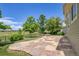 Wide backyard stone patio and fire pit overlooking a golf course and neighborhood at 5131 Netherland St, Denver, CO 80249