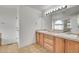 Bathroom featuring a double sink vanity, tile flooring, and framed mirror at 5131 Netherland St, Denver, CO 80249