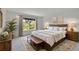 Bedroom with a large window and bright natural lighting, comfortable bedding, and area rug at 5131 Netherland St, Denver, CO 80249