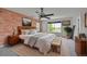 Charming bedroom with brick accent wall, large window, and modern ceiling fan at 5131 Netherland St, Denver, CO 80249