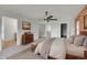 Comfortable bedroom with exposed brick, plush bedding, and modern ceiling fan at 5131 Netherland St, Denver, CO 80249