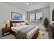 Bedroom featuring natural light, bed with nightstands, neutral colors, and wood frame at 5131 Netherland St, Denver, CO 80249