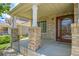 Inviting front porch with brick pillars and a glass-paneled door, creating a warm welcome to the home at 5131 Netherland St, Denver, CO 80249
