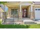 Inviting front porch with brick pillars and a glass-paneled door, creating a warm welcome to the home at 5131 Netherland St, Denver, CO 80249