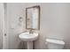 Chic powder room with pedestal sink, bronze fixtures, and a square mirror at 1419 Great Western Dr, Longmont, CO 80501