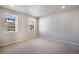 Well-lit bedroom with neutral carpet and two windows at 1419 Great Western Dr, Longmont, CO 80501