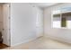 Bedroom featuring white walls, carpet, a window with exterior view and an ensuite bathroom at 1419 Great Western Dr, Longmont, CO 80501