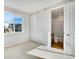 Bedroom featuring a window with view of a building, with attached bathroom at 1419 Great Western Dr, Longmont, CO 80501