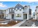 Charming two-story home featuring two-tone gray paint, well-manicured front yard, and inviting entrance at 1419 Great Western Dr, Longmont, CO 80501