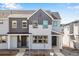 Charming gray two story townhome with a covered front porch and well-manicured landscaping at 1419 Great Western Dr, Longmont, CO 80501