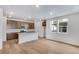 Bright living area with hardwood floors, recessed lighting, windows, and modern kitchen at 1419 Great Western Dr, Longmont, CO 80501