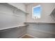 Walk-in closet featuring white walls, carpet, window and white shelving at 1419 Great Western Dr, Longmont, CO 80501