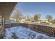 Wooden deck with snow covered surface, offering views of the neighborhood at 68 W 81St Pl, Denver, CO 80221