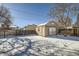 Detached shed in snowy backyard with wooden fence at 68 W 81St Pl, Denver, CO 80221