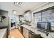 Kitchen with granite countertops and gray cabinets at 68 W 81St Pl, Denver, CO 80221