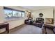 Living room with large window and brown leather furniture at 68 W 81St Pl, Denver, CO 80221