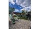 Cozy backyard featuring a stone patio, pergola with seating, and lush green landscaping, perfect for outdoor relaxation at 1434 Osceola St, Denver, CO 80204