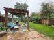 Relaxing backyard area featuring stone patio, pergola with seating, and lush greenery at 1434 Osceola St, Denver, CO 80204