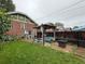 Spacious backyard with lawn, pergola, brick house, and ample greenery at 1434 Osceola St, Denver, CO 80204