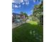 Green backyard featuring a charming pergola, grassy area, landscaping, and shed, creating a serene outdoor space at 1434 Osceola St, Denver, CO 80204