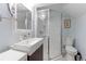 Cozy bathroom with glass-enclosed shower, floating sink, and framed mirror at 1434 Osceola St, Denver, CO 80204