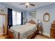 Comfortable bedroom with blue walls, natural light and hardwood floors at 1434 Osceola St, Denver, CO 80204