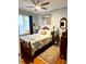 Charming bedroom with hardwood floors, ceiling fan, and natural light from the window at 1434 Osceola St, Denver, CO 80204