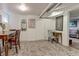 Finished basement dining area with wood table, decorative rug, and access to the living room at 1434 Osceola St, Denver, CO 80204