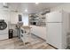 Basement kitchen featuring bright white cabinets, butcher block countertops and stainless appliances at 1434 Osceola St, Denver, CO 80204