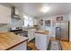 Bright kitchen featuring butcher block countertops, stainless steel appliances, and ample storage at 1434 Osceola St, Denver, CO 80204