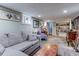 Basement living area featuring neutral walls, built-in bookshelves, wood floors and comfortable furniture at 1434 Osceola St, Denver, CO 80204