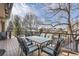 Outdoor dining set on a wood deck, surrounded by a black metal safety railing at 3982 W 103Rd Ave, Westminster, CO 80031