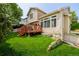Beautiful backyard with a spacious deck, lush green lawn, and well-maintained landscaping and charming home at 527 English Sparrow Trl, Highlands Ranch, CO 80129