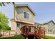 Exterior view of backyard featuring a spacious deck with access from the house, and green grass at 527 English Sparrow Trl, Highlands Ranch, CO 80129