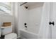 Bathroom with white tiled shower/tub and modern black fixtures at 527 English Sparrow Trl, Highlands Ranch, CO 80129